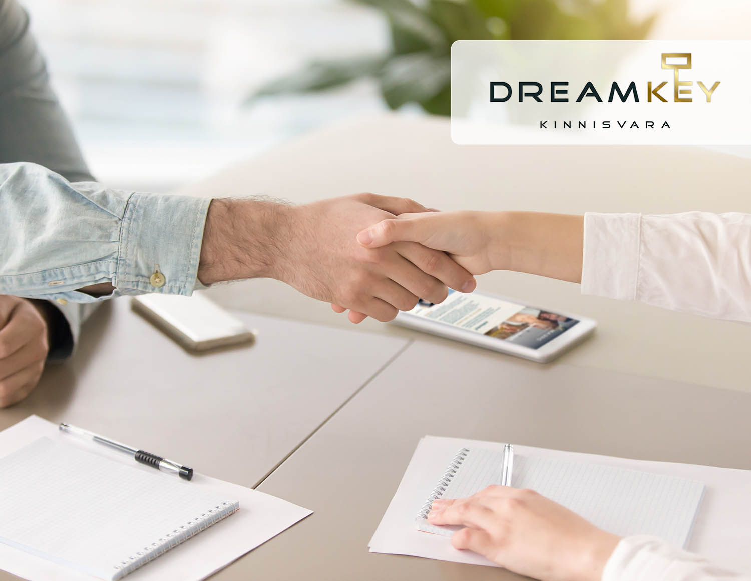 Male hand shaking hand of young female over office desk